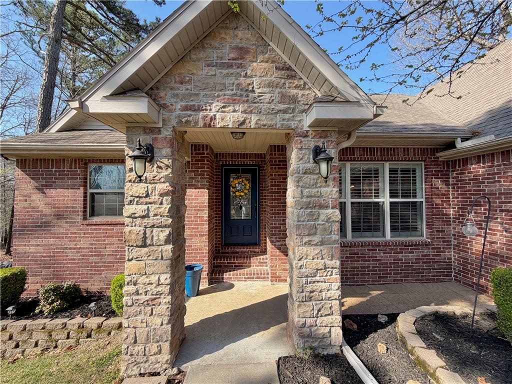 Image 3: Property entrance featuring brick siding