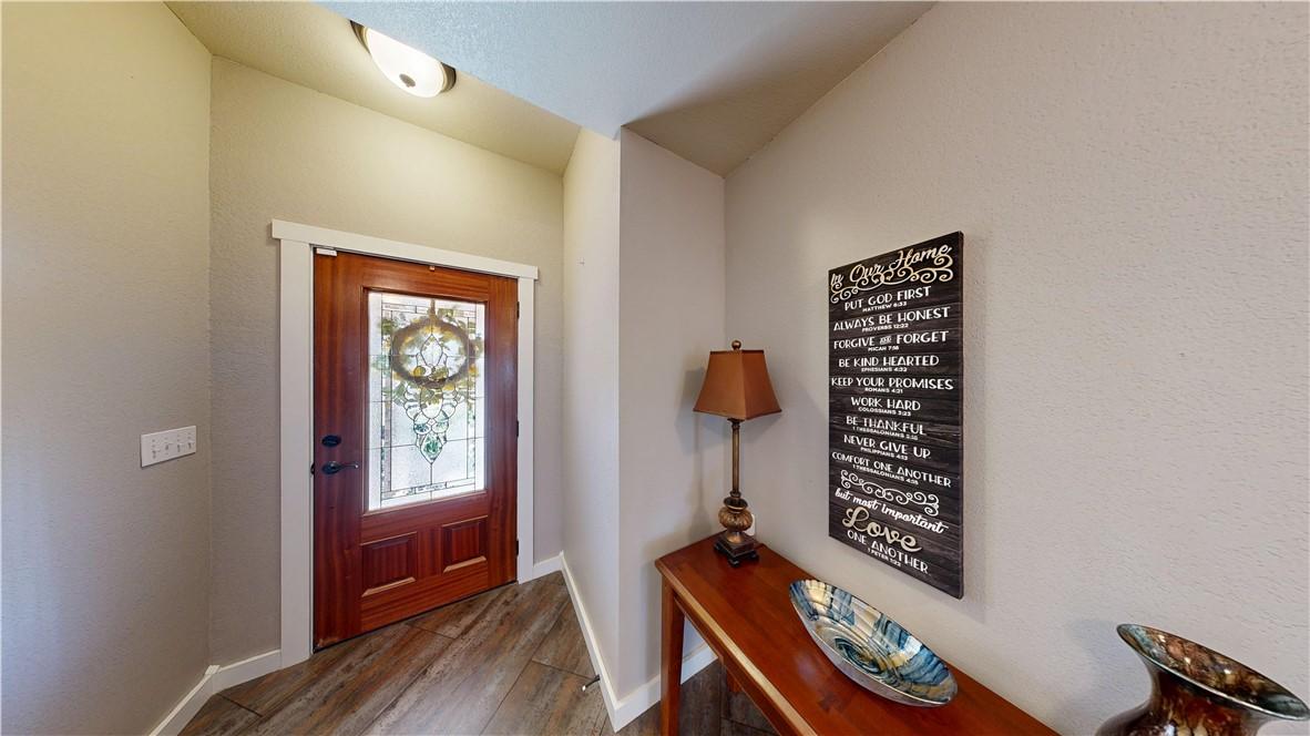 Image 4: Entryway featuring baseboards and wood finished fl