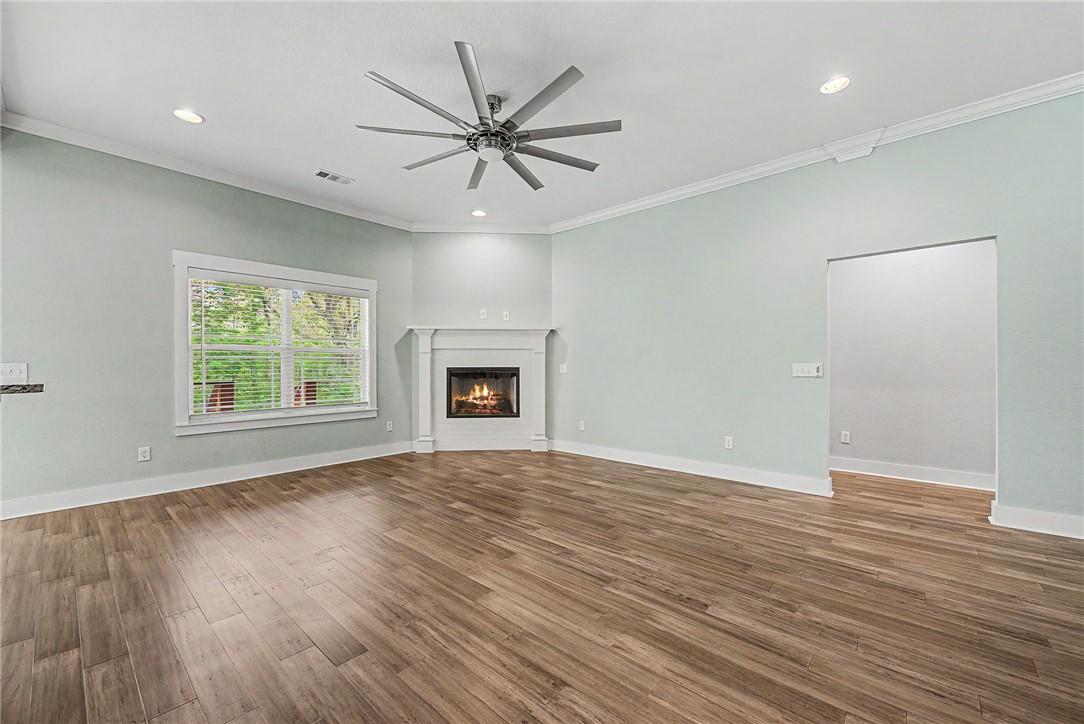 Image 4: Spacious living area featuring wood-look flooring,