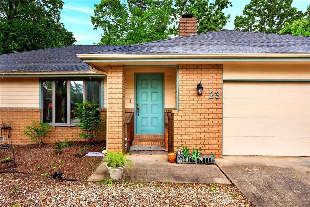 Image 2: Brick and siding exterior featuring a turquoise en