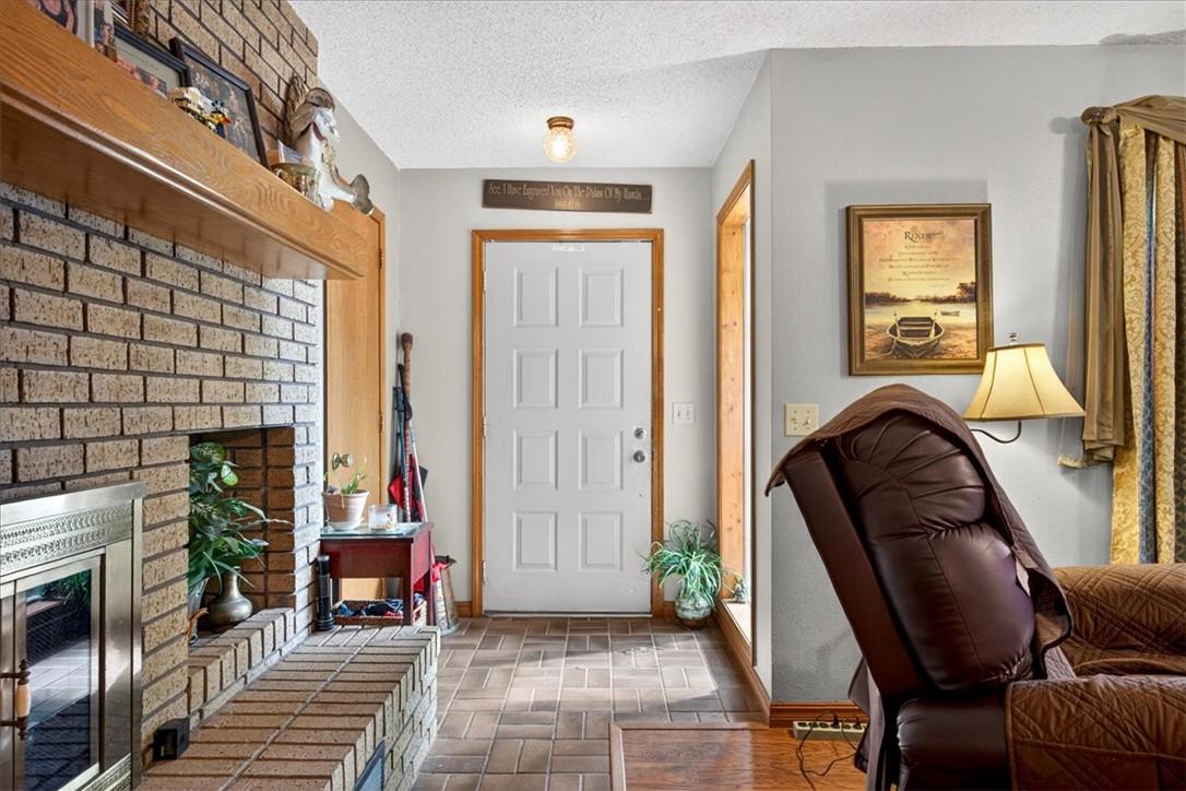 Image 4: Entryway featuring a white paneled door with natur