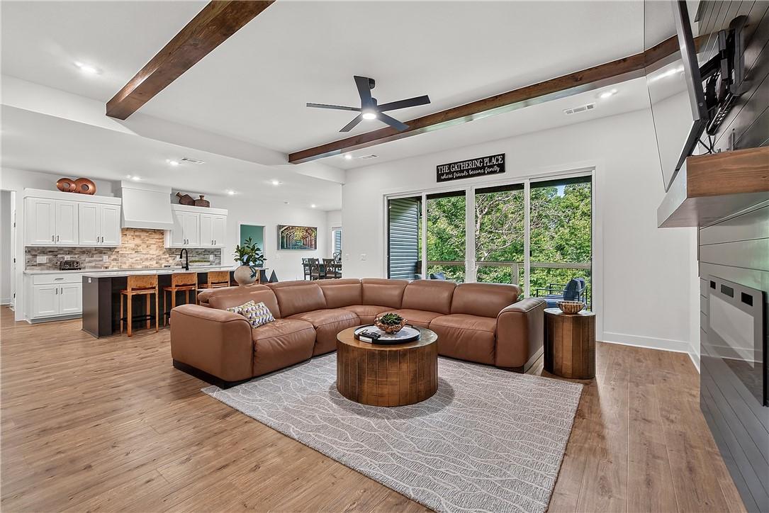 Image 4: Open-concept living space featuring wood-finish fl