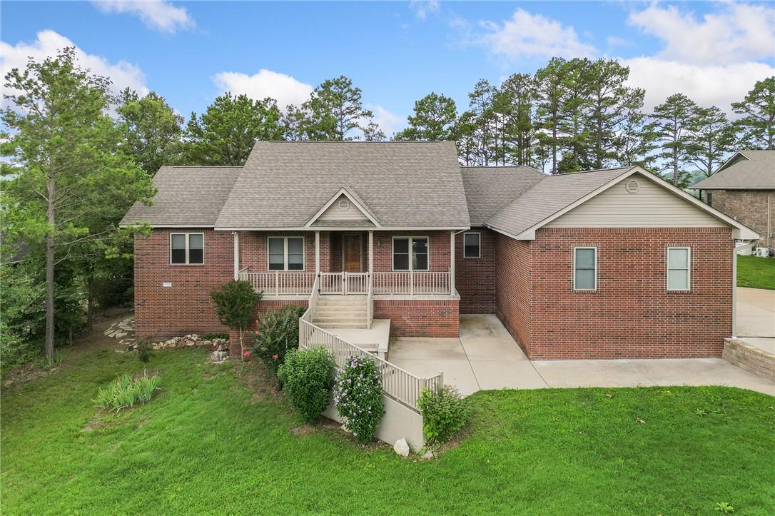 Image 1: Brick exterior residence featuring a covered front
