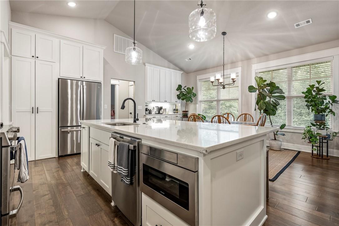Image 4: Spacious kitchen featuring an expansive central is