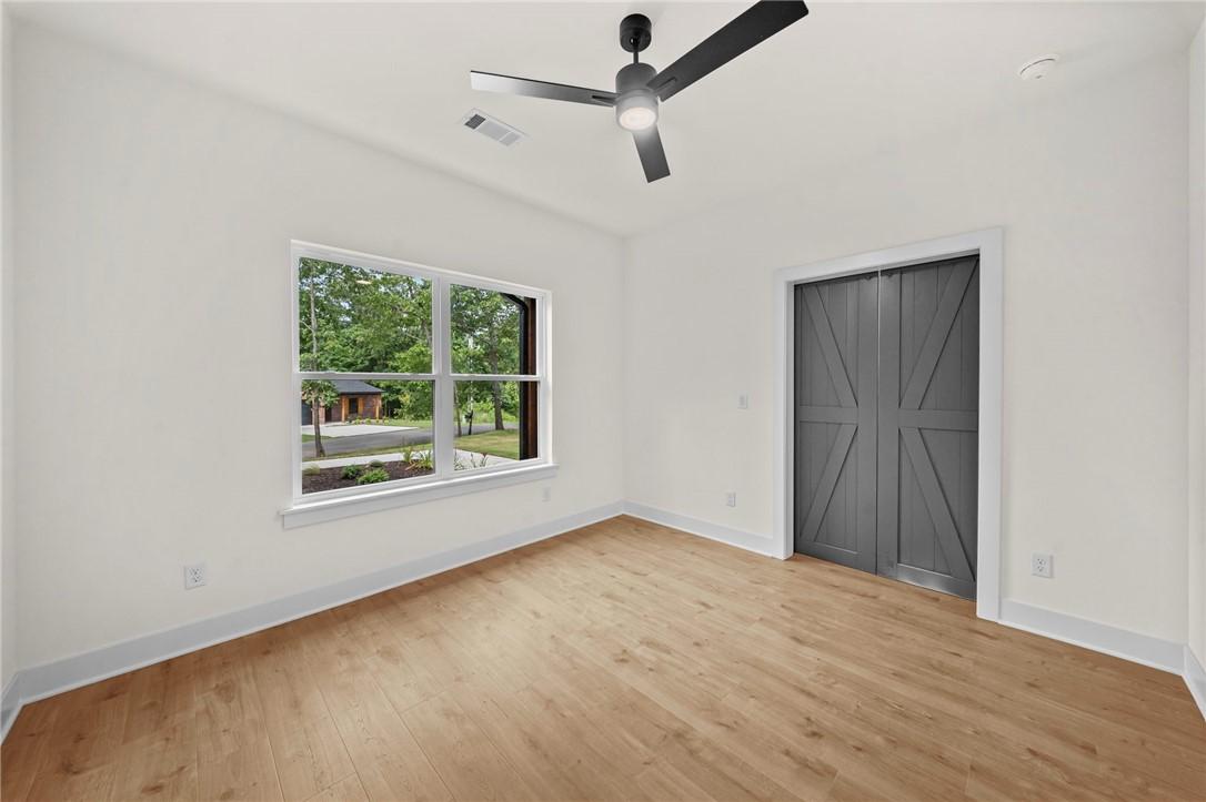 Image 3: Hardwood-finish flooring complementing white walls