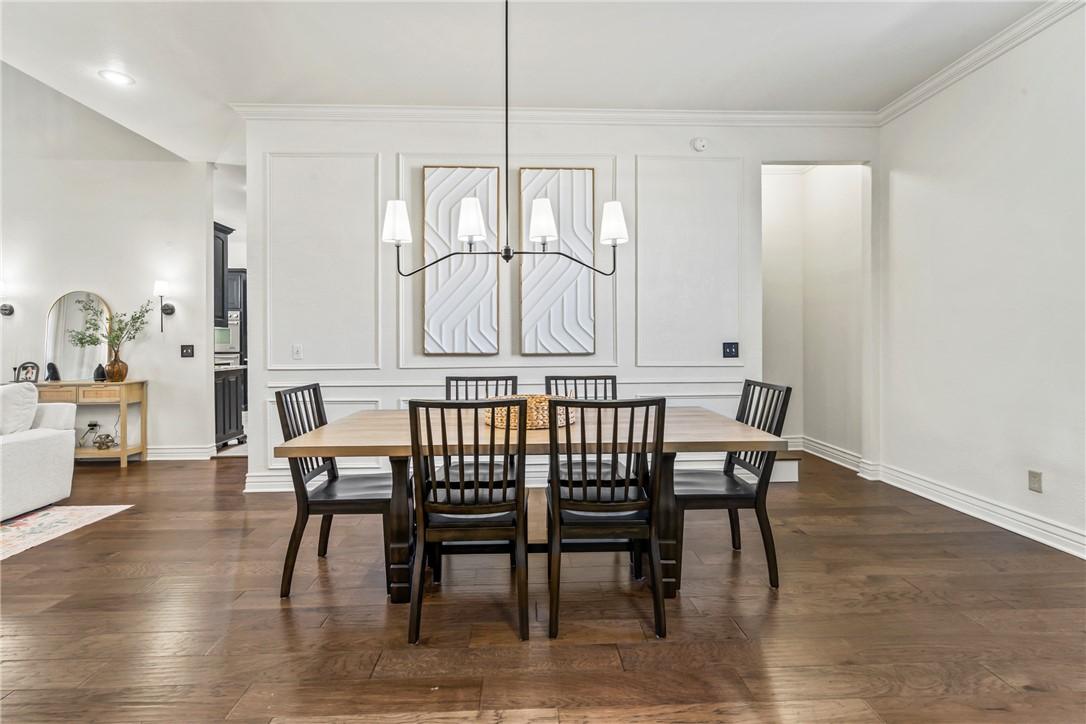 Image 2: Dining space with dark wood-style flooring, new su