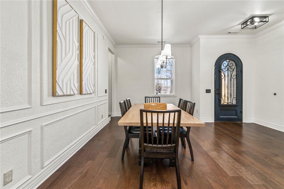 Image 4: The formal dining space features an accent wall wi