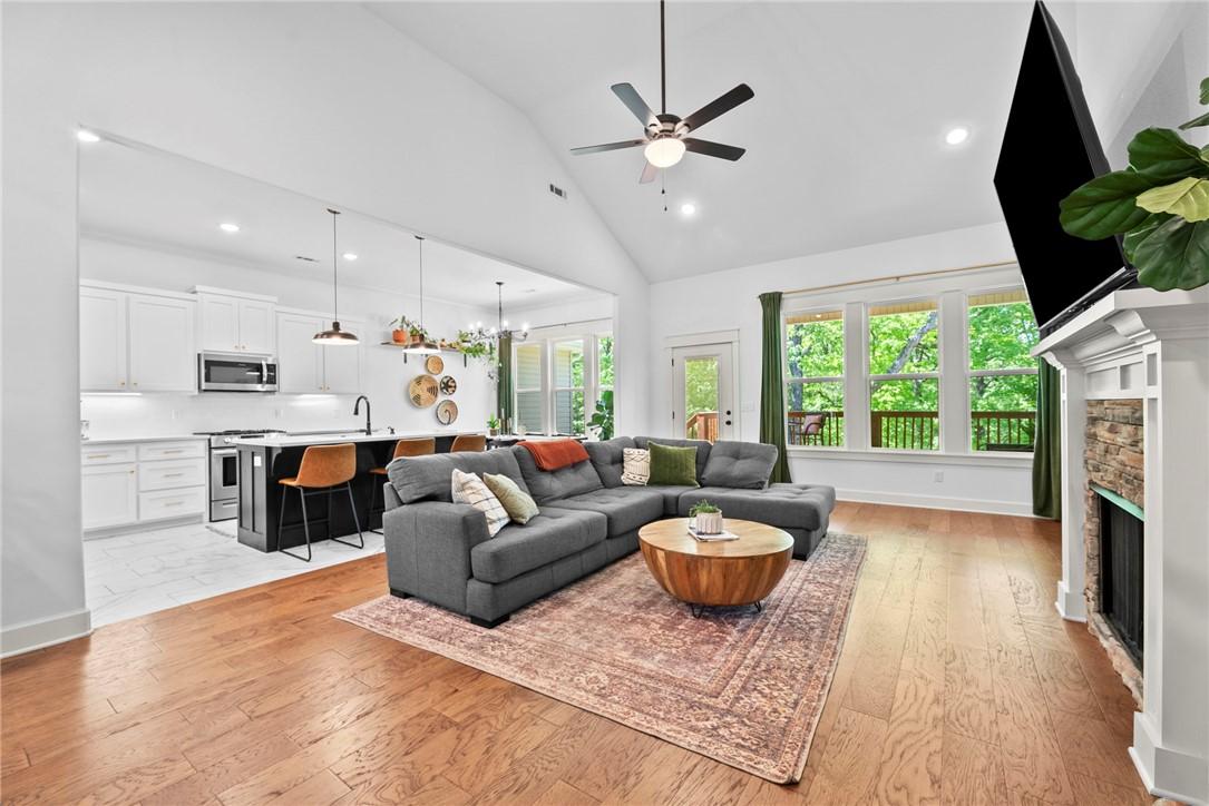 Image 3: Open-concept living space featuring wood-finish fl