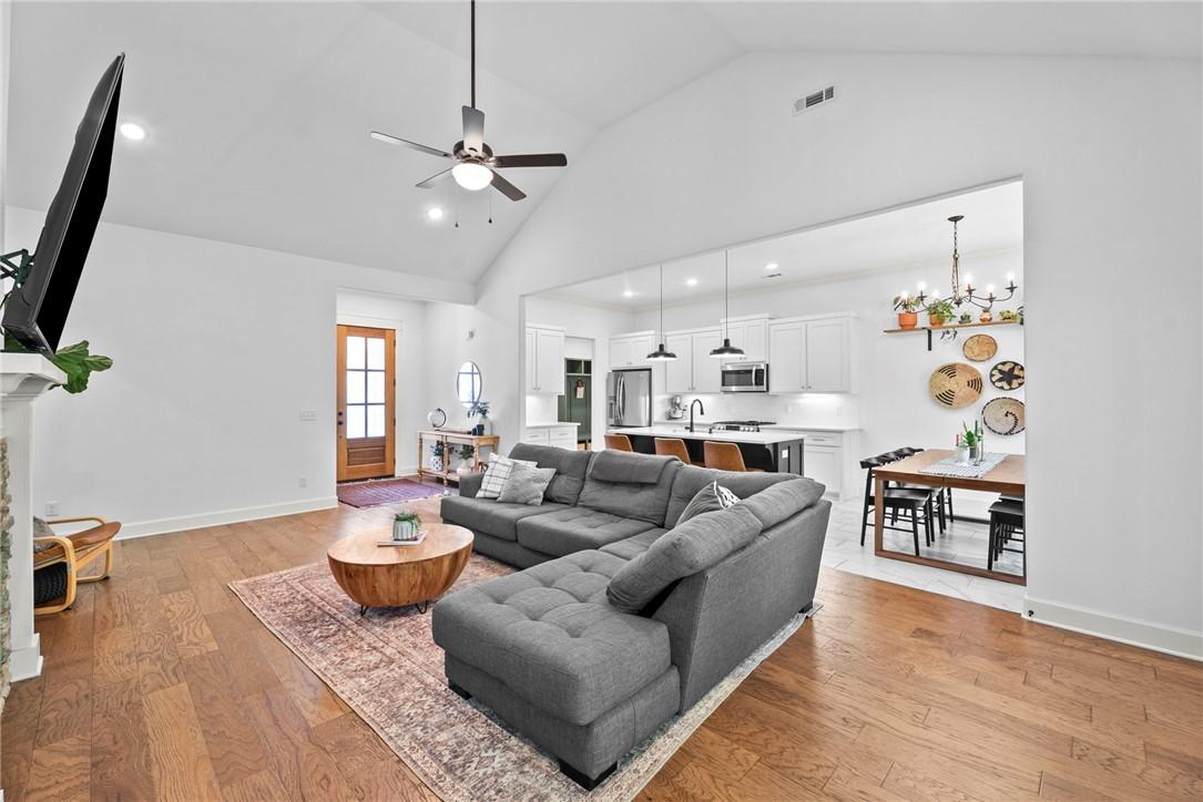 Image 4: Spacious living area featuring wood-finish floorin