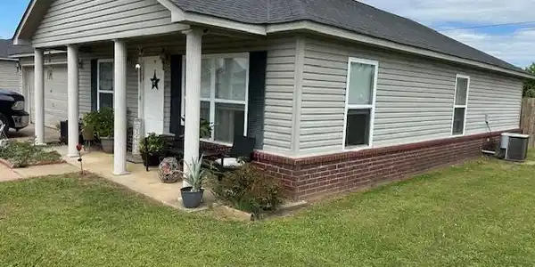 Image 2: Ranch-style exterior featuring light-colored sidin