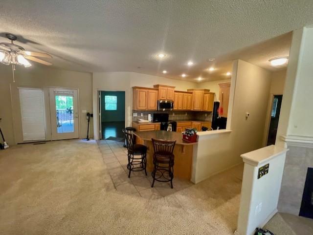 Image 2: Open concept kitchen featuring wood-finish cabinet