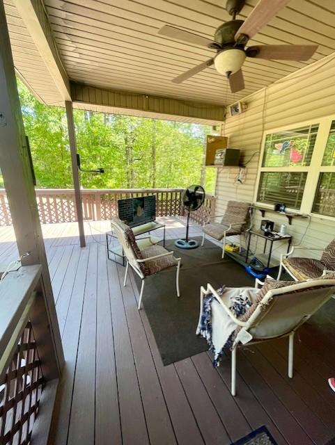 Image 3: Covered outdoor deck with wood plank flooring