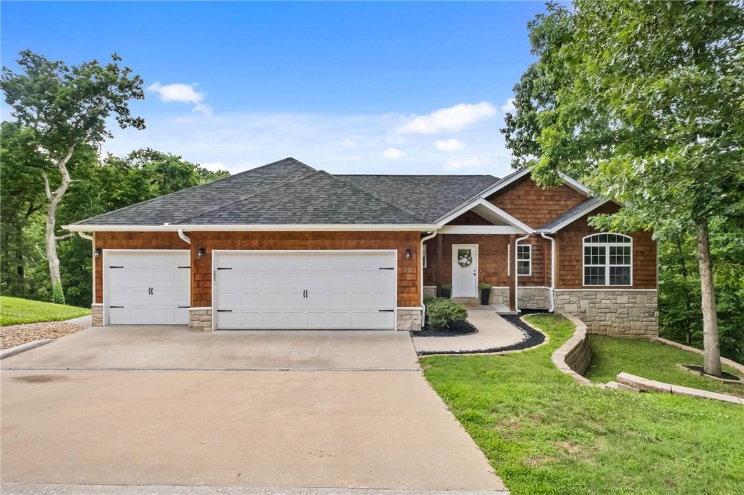 Image 1: Craftsman-style residence featuring a three-car ga