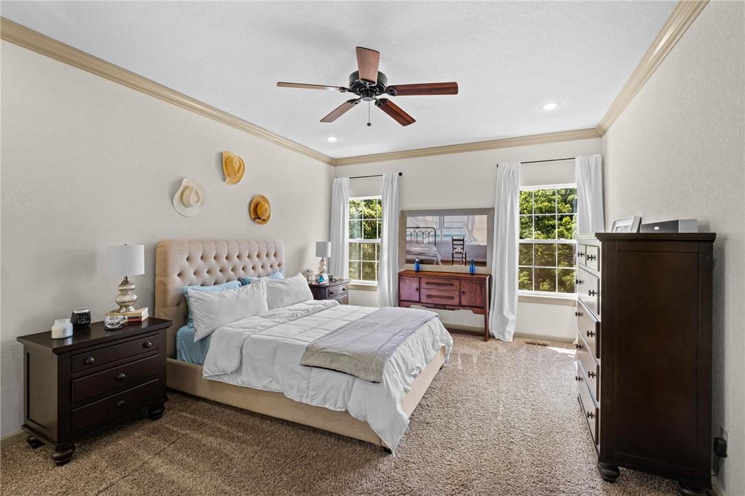 Image 4: Bedroom featuring two large windows, crown molding
