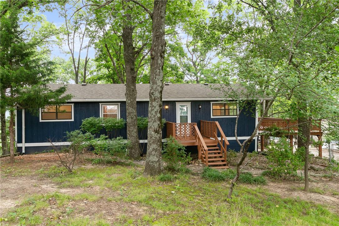 Image 2: Dark blue exterior siding with white trim, featuri