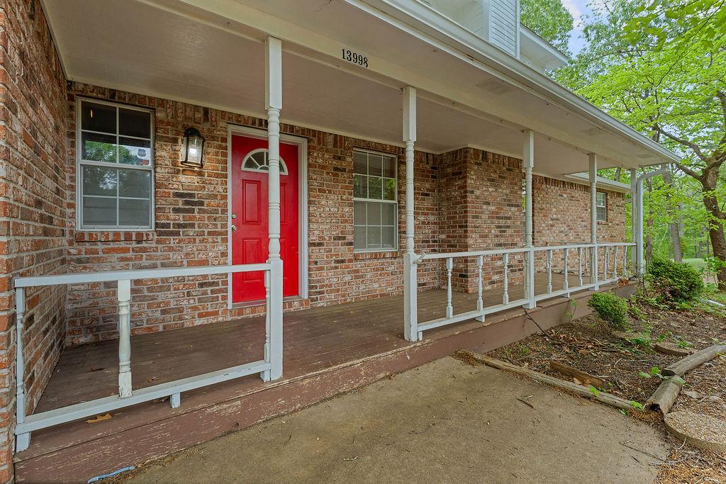 Image 2: Inviting front porch featuring a vibrant red entry
