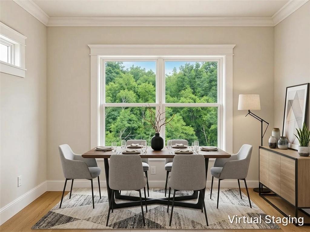 Image 4: Dining area featuring a large window, a smaller tr