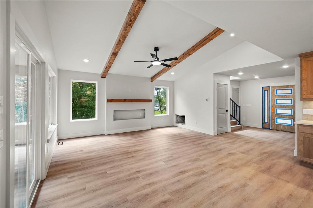 Image 2: Vaulted ceilings with exposed wood beams define th