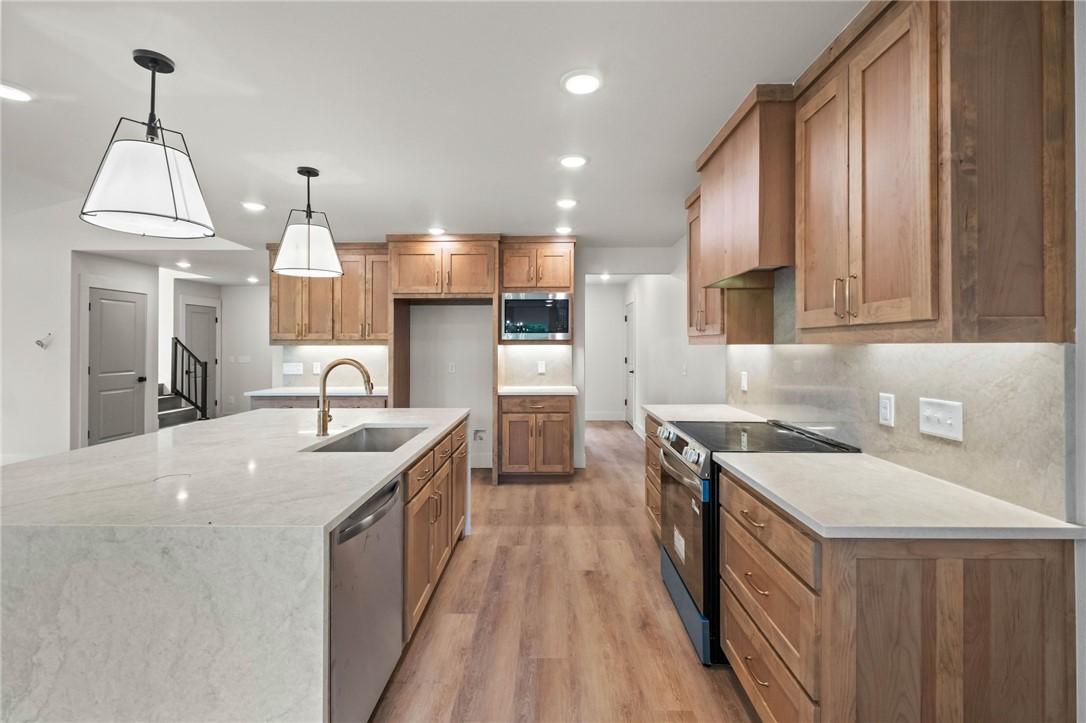 Image 4: Open-concept kitchen featuring an expansive island
