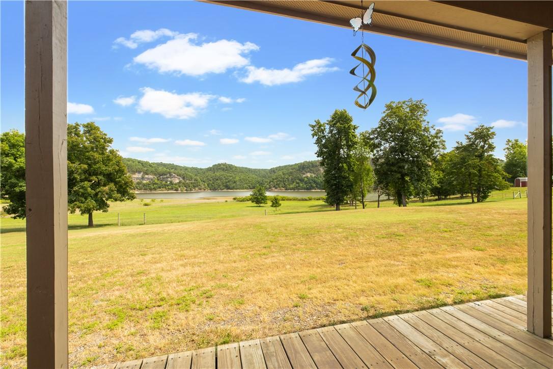 Image 3: Spacious wood-finish porch overlooking expansive g