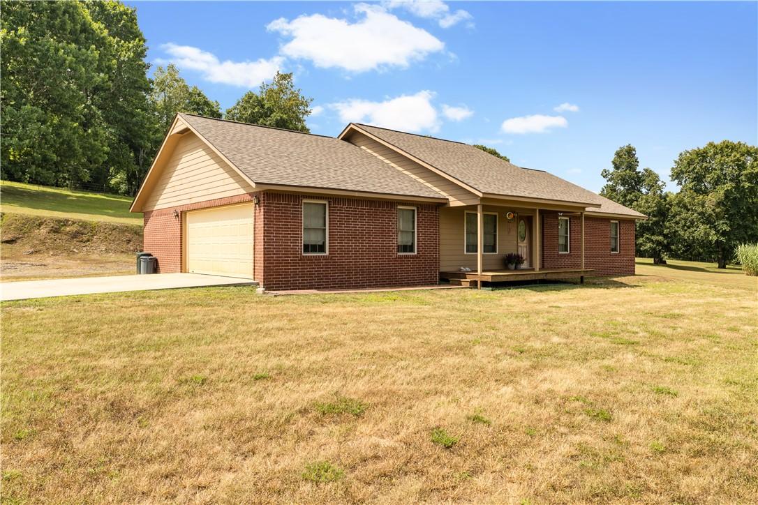 Image 4: Brick and siding home featuring a covered front po