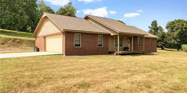 Image 4: Brick and siding home featuring a covered front po