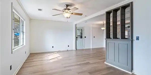 Image 3: Empty room with ceiling fan, light wood-style floo