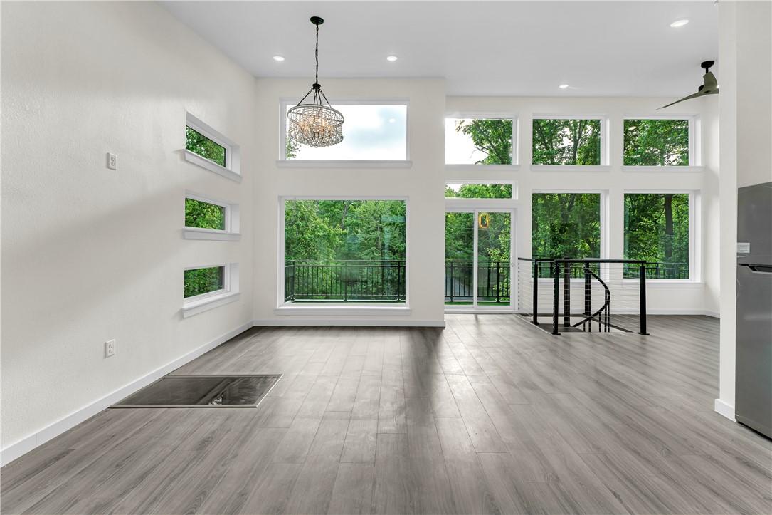 Image 4: High ceilings complement the wood-finish flooring