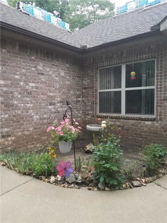 Image 2: Property entrance with brick siding and roof with