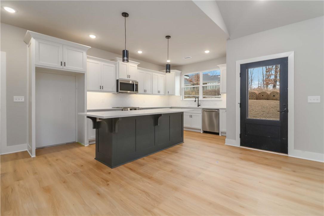 Image 2: Kitchen featuring a kitchen breakfast bar, hanging