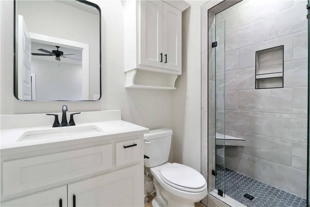 Image 4: Full bathroom featuring a shower stall, vanity, an