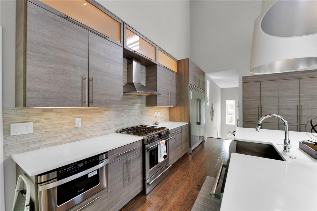 Image 4: Contemporary kitchen featuring wood-finish cabinet