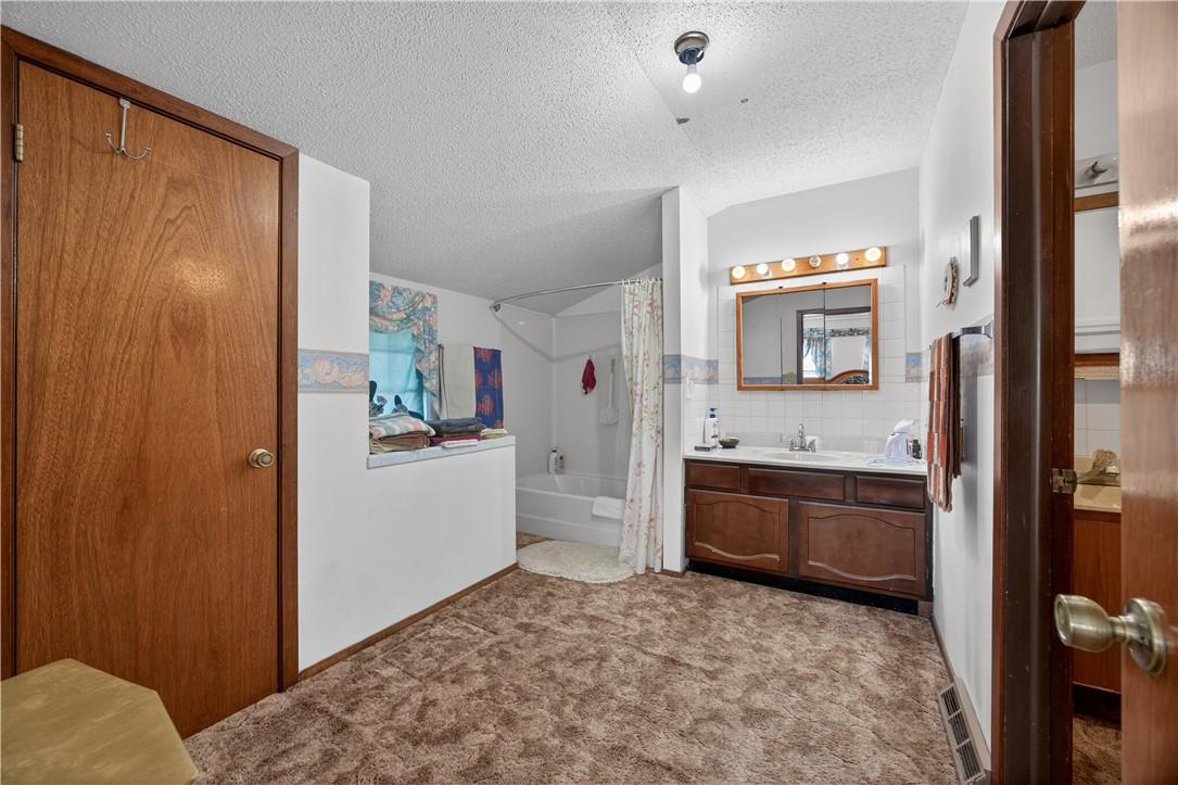 Image 4: Bathroom off Primary Bedroom.