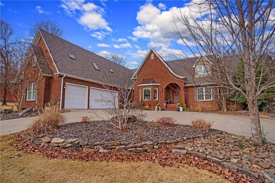 Image 1: Traditional home with brick siding, concrete drive