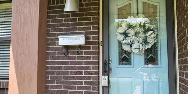Image 4: Entrance to property with brick siding and a porch