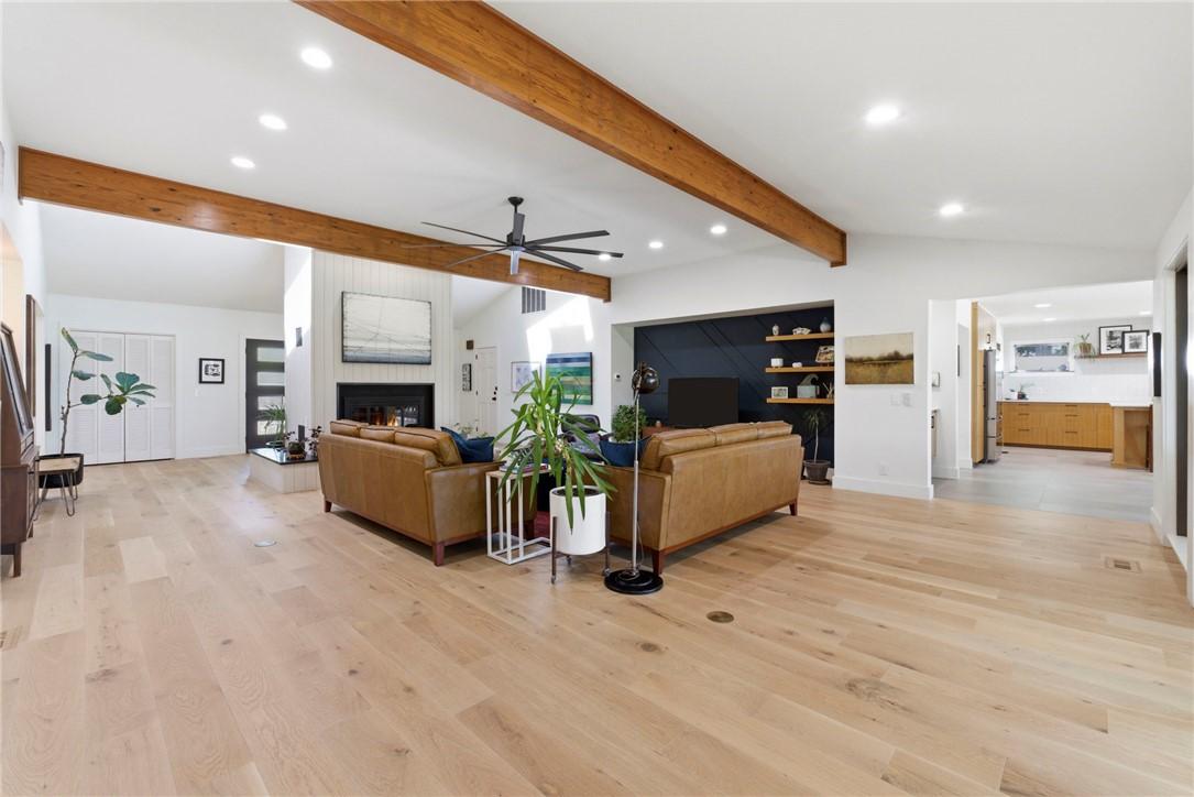 Image 2: Open-concept living space featuring light wood-fin
