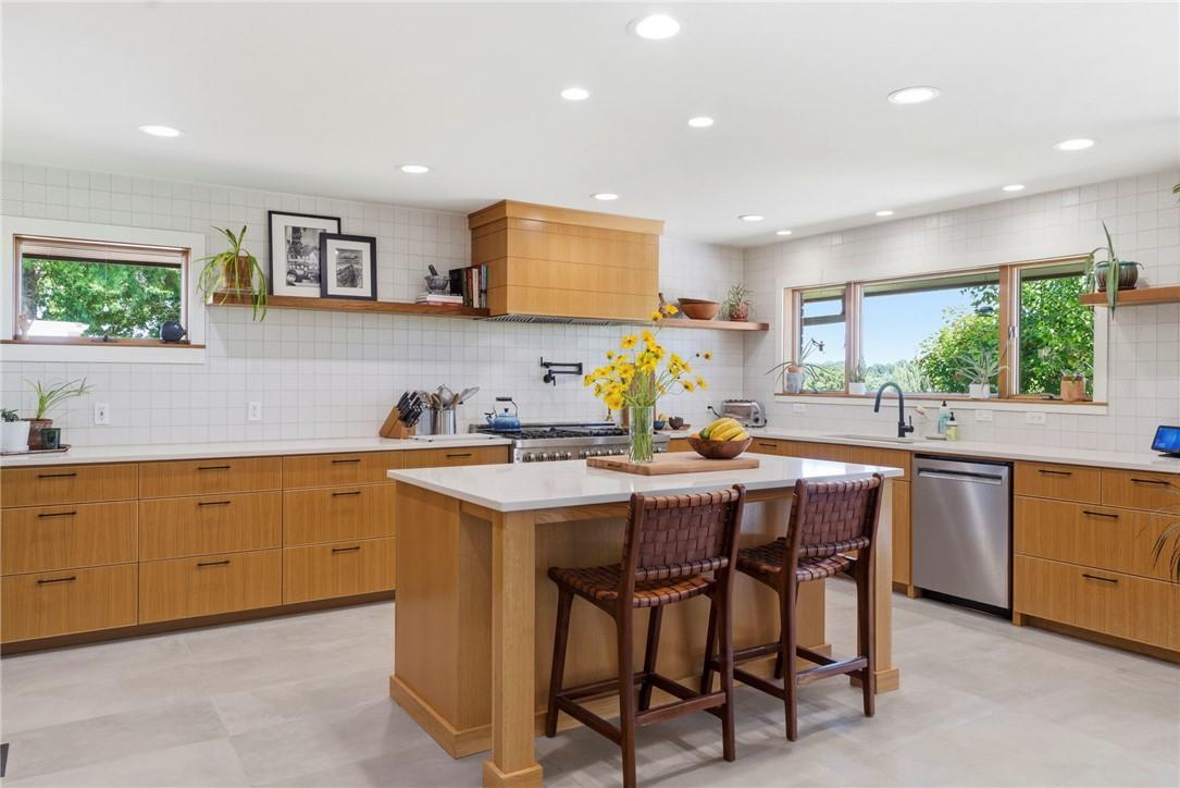 Image 3: Spacious kitchen featuring an expansive central is