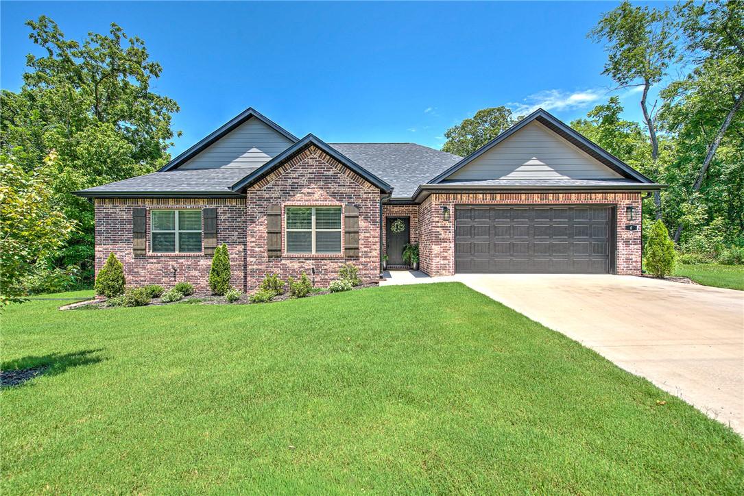 Image 2: Brick facade residence with a two-car garage and c