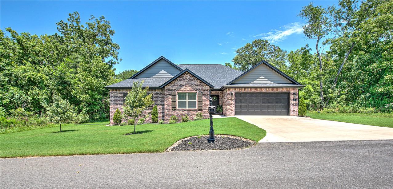 Image 3: Brick and stone facade with dark gray siding accen