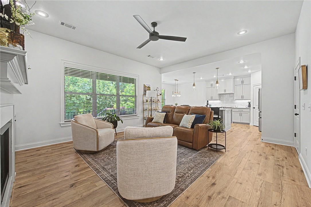 Image 4: Open-concept living area featuring wood-finish flo