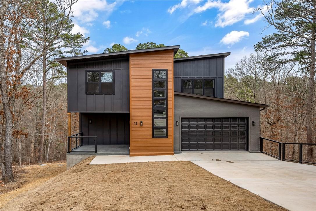 Image 1: Contemporary house featuring driveway and an attac