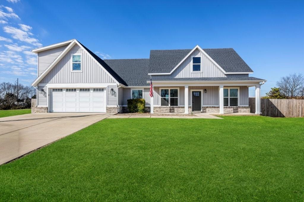 Image 2: Modern farmhouse style home with stone siding, a p