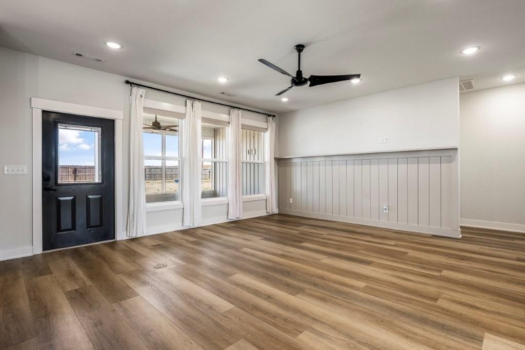 Image 4: Empty room with ceiling fan, wood finished floors,