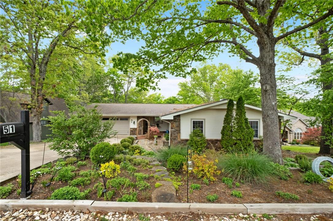 Image 1: Ranch-style residence featuring a stone and siding
