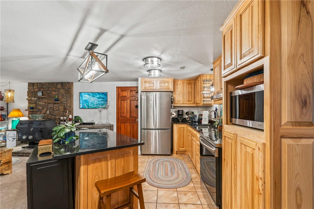 Image 4: Updated kitchen with stainless appliances.