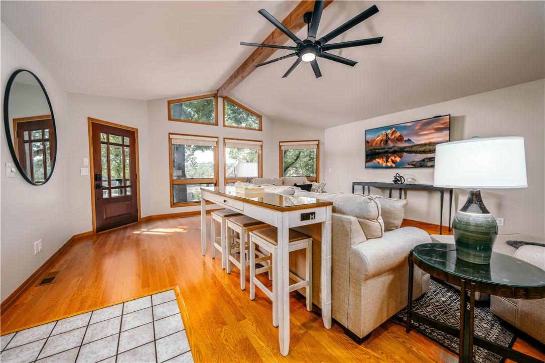 Image 3: The living room features large windows that look o