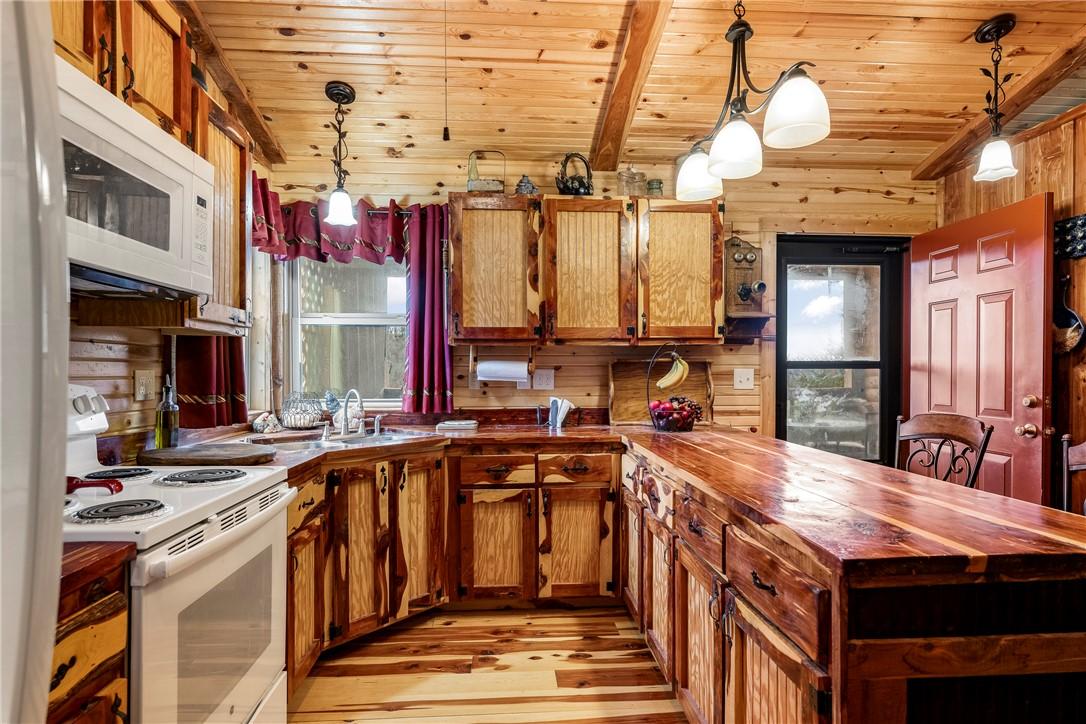 Image 4: Kitchen with white appliances, butcher block count
