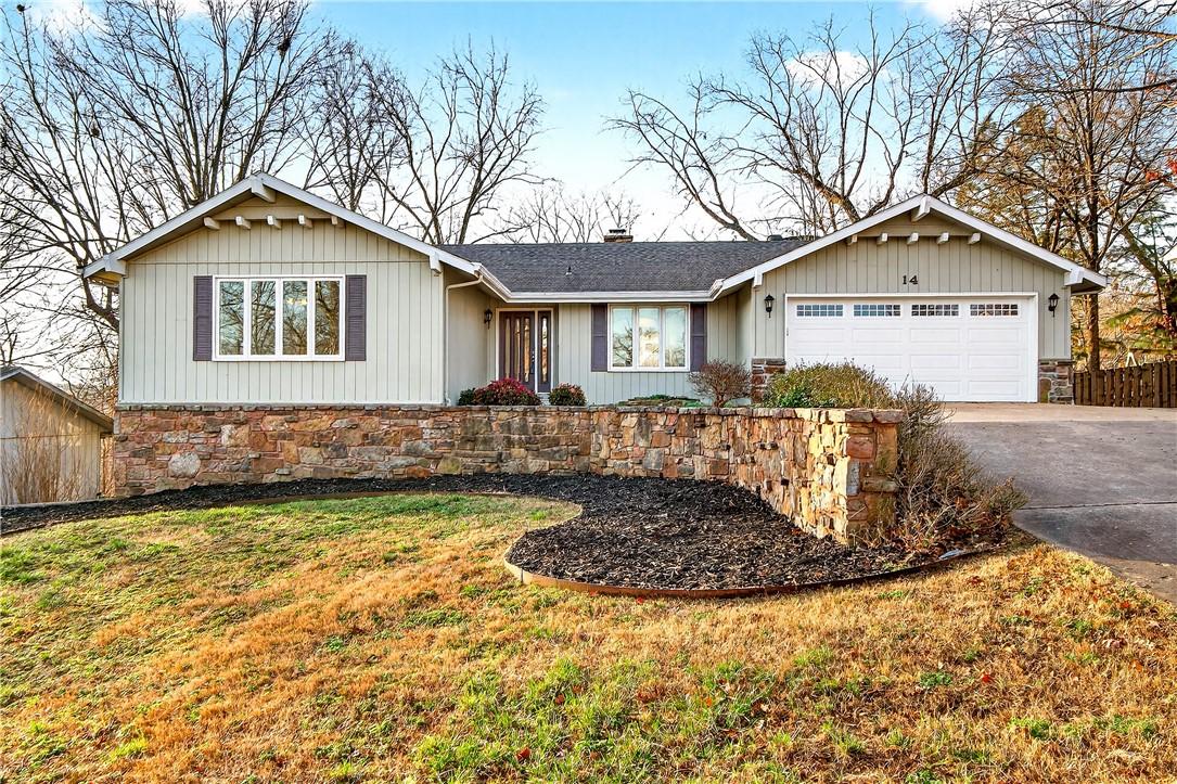 Image 1: Single story home with an attached garage, a chimn
