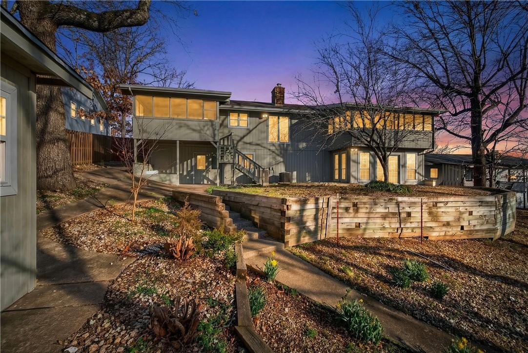 Image 2: Rear view of property with stairway and a chimney