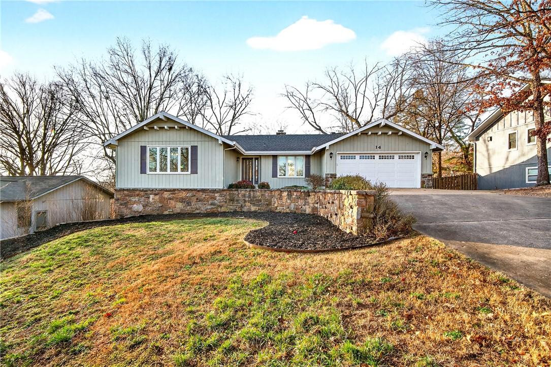 Image 3: Single story home with a garage, driveway, and a c